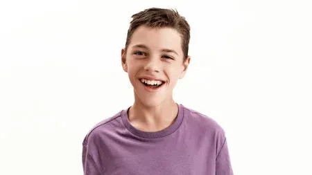 Smiling boy in a purple T-shirt