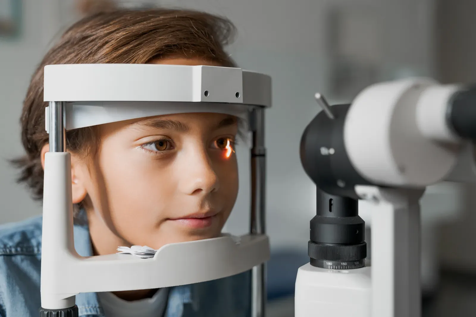 A child having their eye health examined at the slit lamp