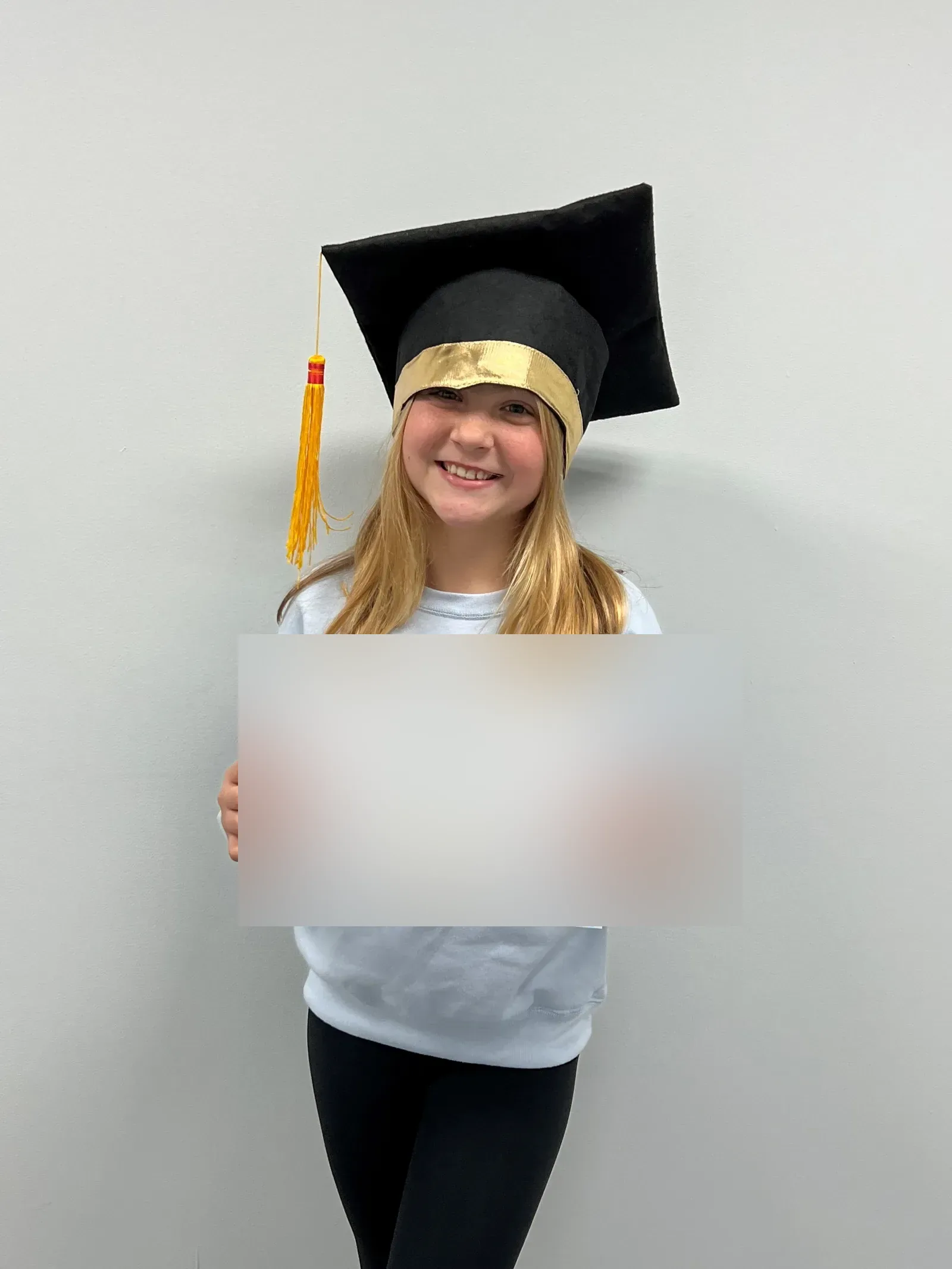 A vision therapy graduate holding their certificate