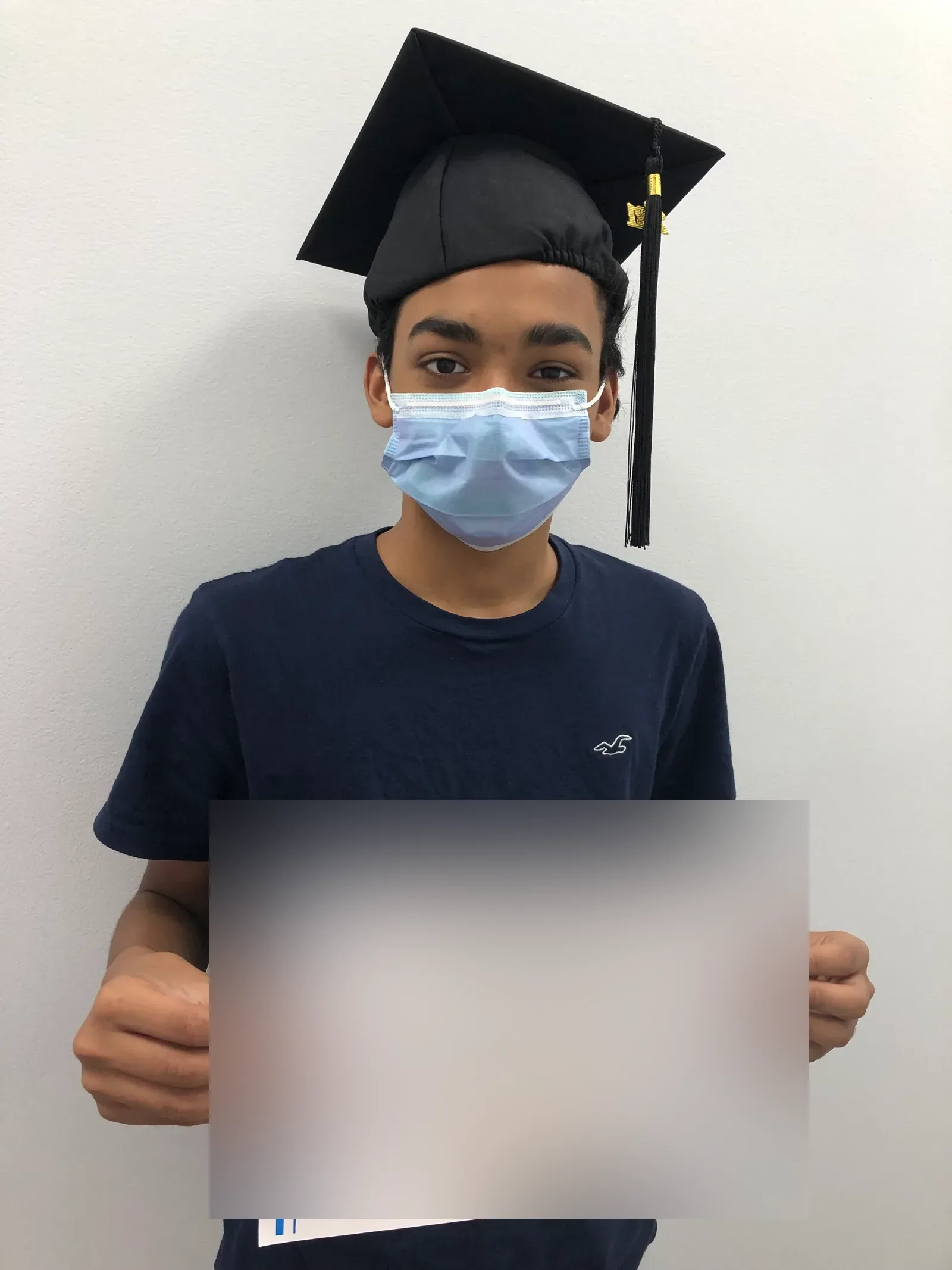 A vision therapy graduate holding their certificate