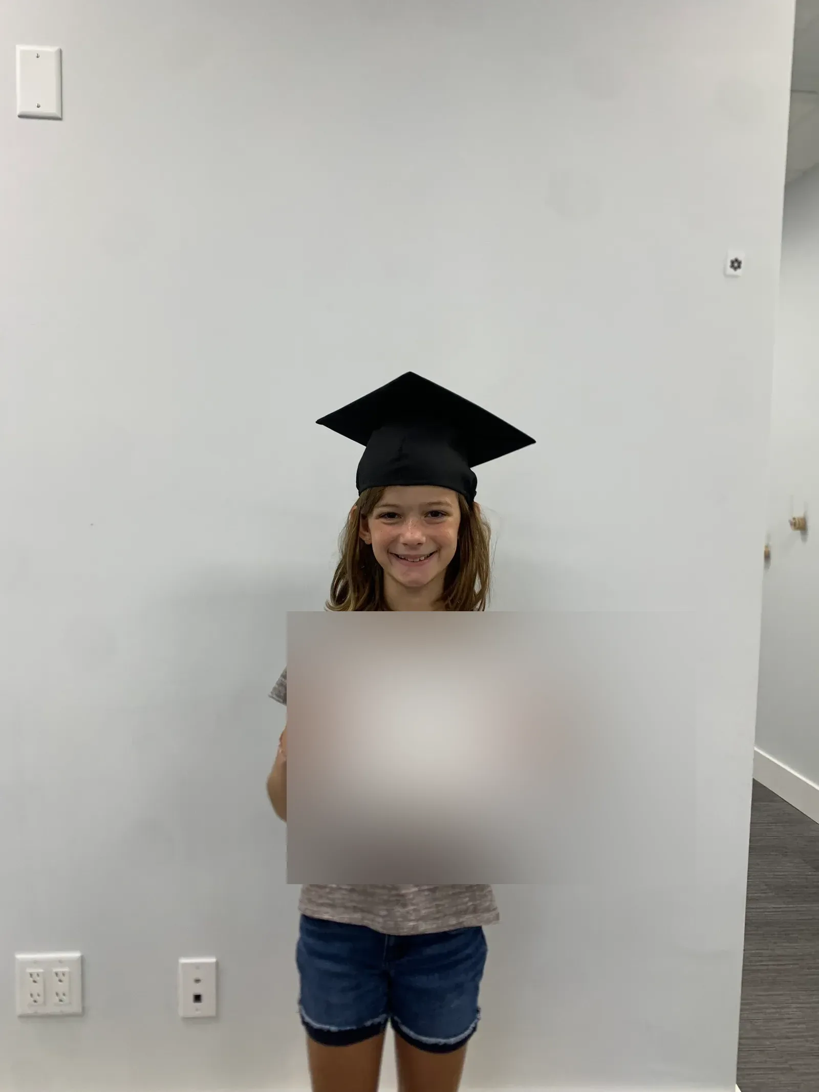 A vision therapy graduate holding their certificate