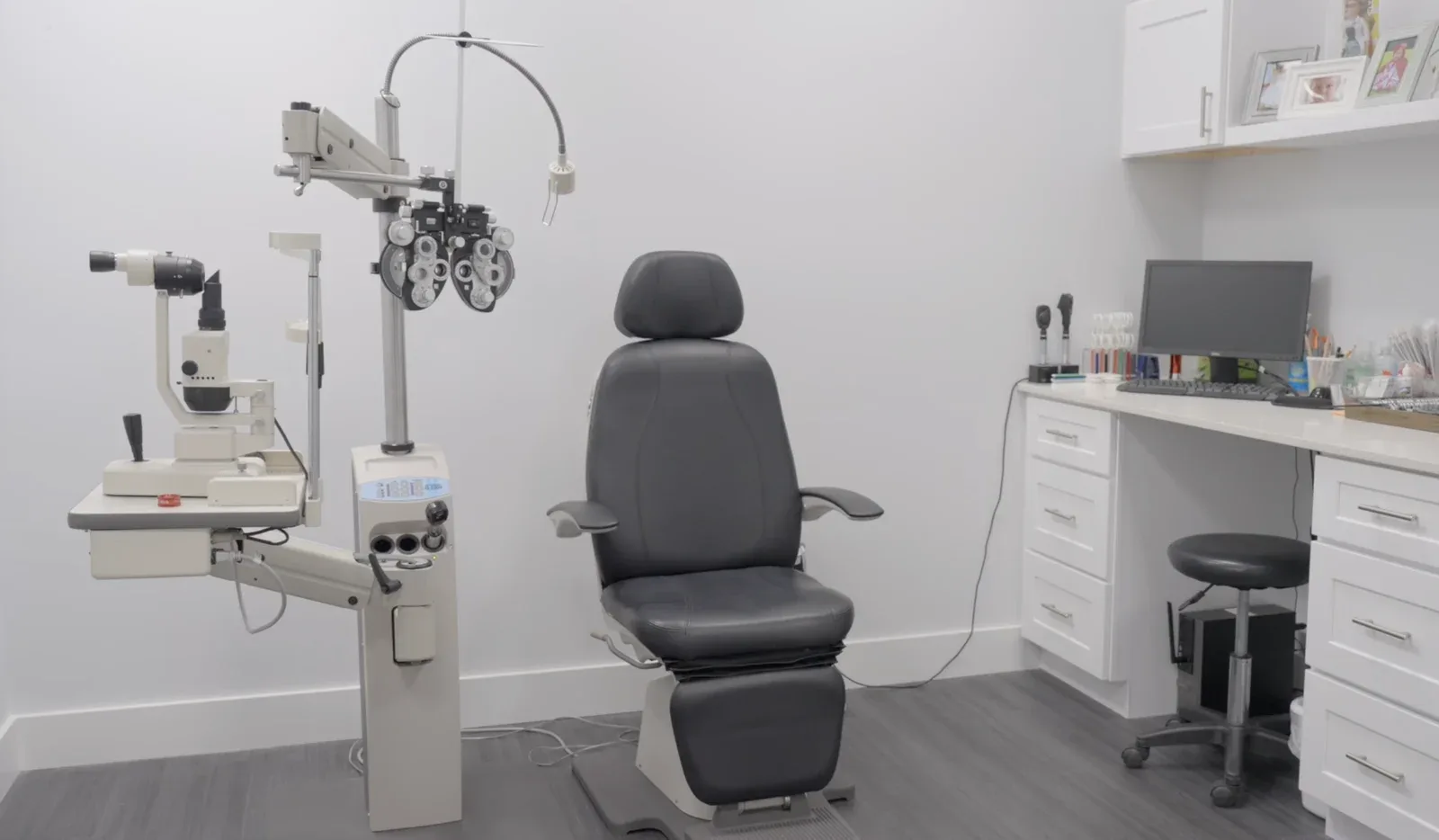 An exam room with an examination chair and testing equipment at the Boynton Beach office