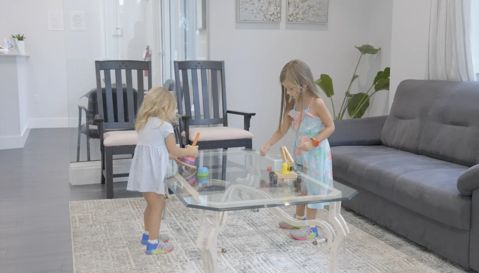 Two children playing at a table in the waiting area of the Coconut Creek office