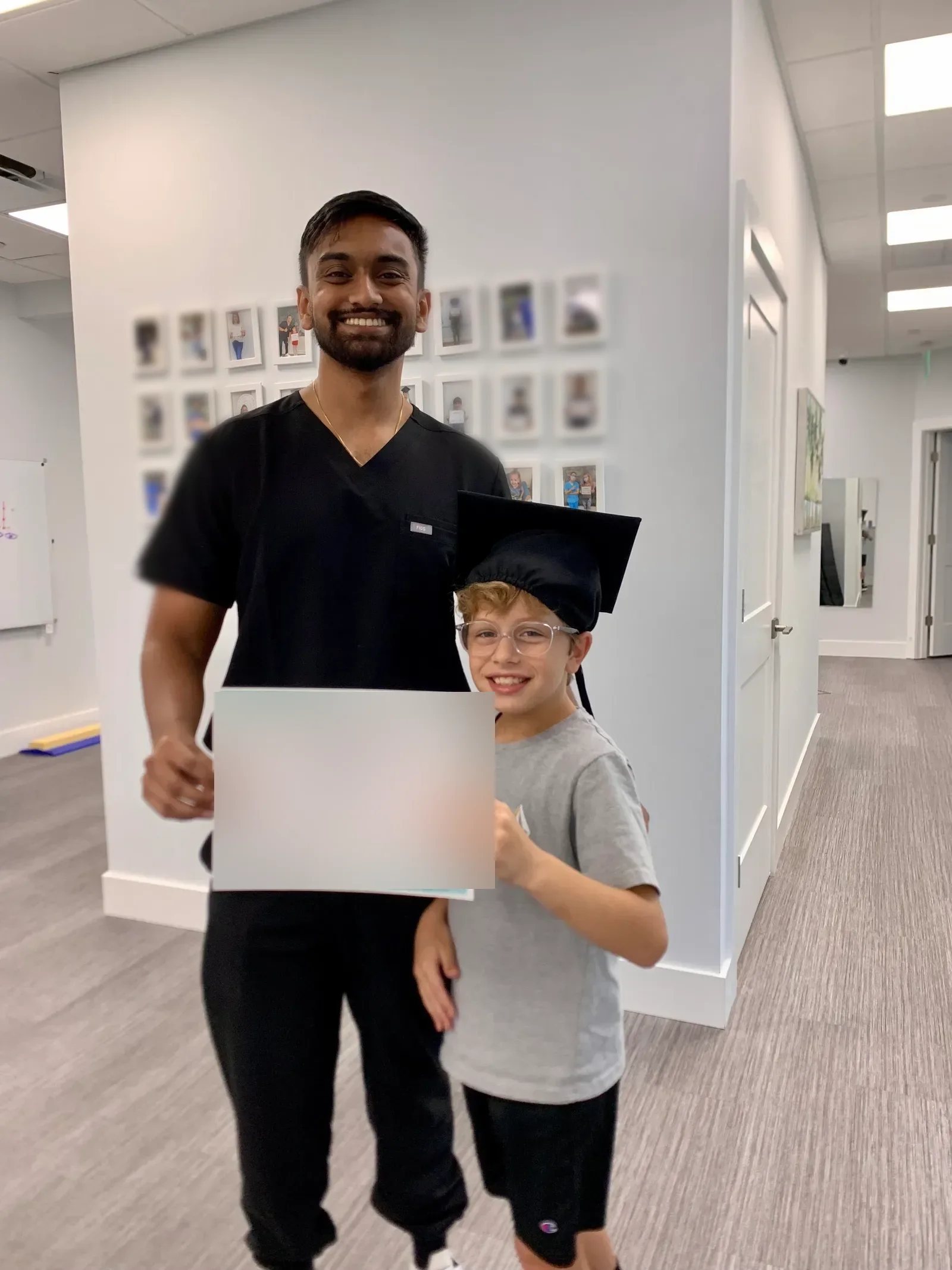 A vision therapist and a patient in the hallway of a Vision & Learning Center office