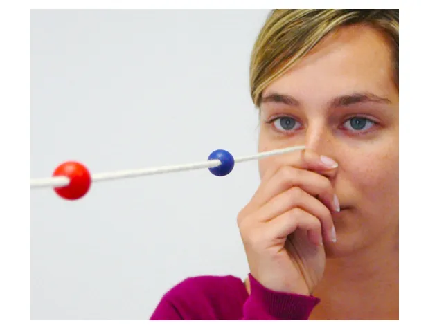 A Brock string: a long white cord threaded with colored beads used to give feedback on eye alignment during vision therapy.